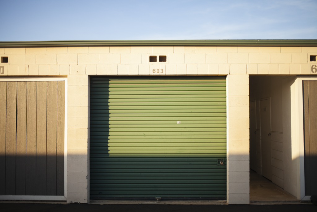 a green garage door with two doors